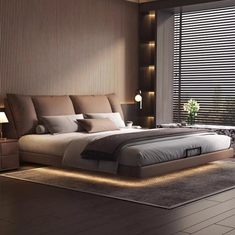 Modern leather double bed in a minimalist master bedroom design with stylish lighting.