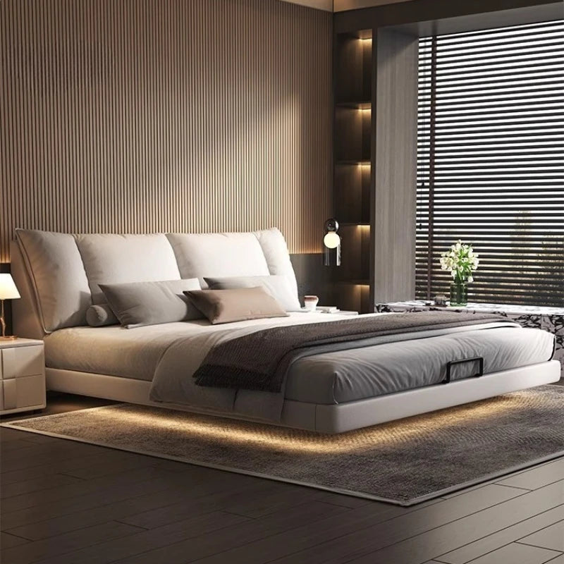 Modern leather double bed in a minimalist master bedroom design with soft lighting and stylish decor.