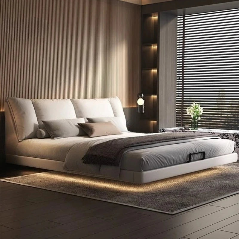 Modern leather double bed in a minimalist master bedroom with stylish decor and ambient lighting.