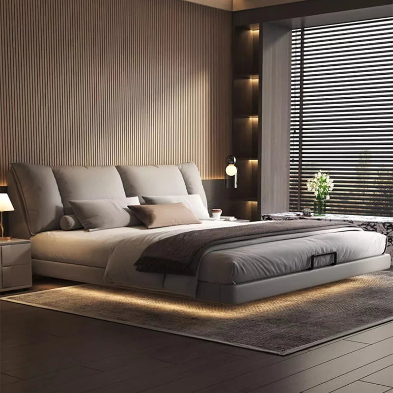 Modern leather double bed in a minimalist master bedroom with sleek design and soft lighting.
